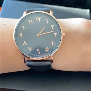 Rose gold black strap watch with Arab writing